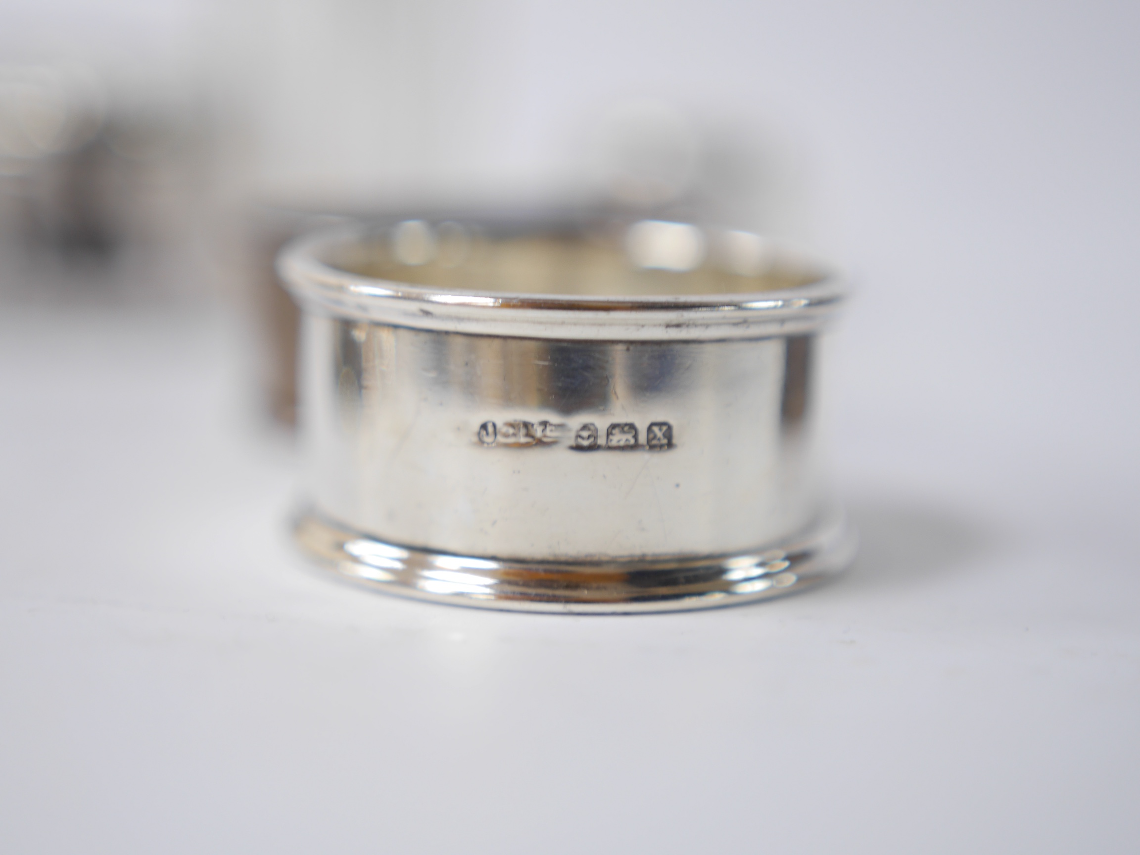 An Edwardian repousse silver dressing table tray by William Comyns, London, 1901, 23.3cm, together with four assorted silver mounted glass toilet jars, two silver mounted glass salts and three napkin rings. Condition - p